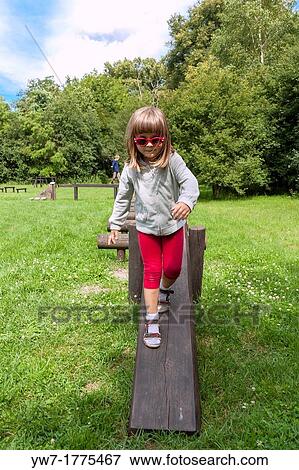 Girl walking on balance beam View Large Photo Image Stock Photo - Girl walking on balance beam. Fotosearch
