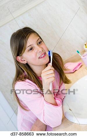 Girl washing her teeth in the bathroom View Large Photo Image Stock Image - Girl washing her teeth in the bathroom. Fotosearch