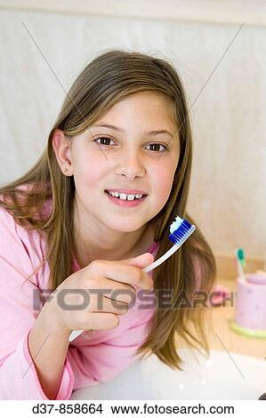 Girl washing her teeth View Large Photo Image Picture - Girl washing her teeth. Fotosearch