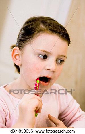 Girl washing her teeth View Large Photo Image Stock Photograph - Girl washing her teeth. Fotosearch