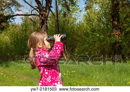 Girl watching birds through binoculars in a forest. View Large Photo Image Stock Image - Girl watching birds through binoculars in a forest.. Fotosearch
