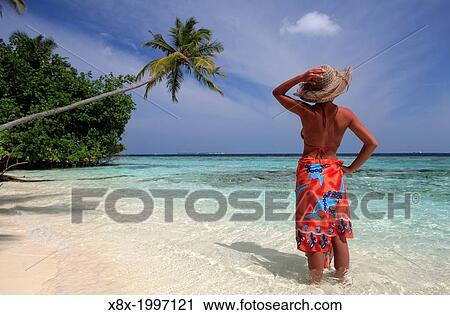 Girl watching the Ocean at the seashore, Biyadhoo island, Maldives. View Large Photo Image Stock Image - Girl watching the Ocean at the seashore, Biyadhoo island, Maldives.. Fotosearch