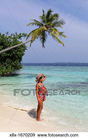 Girl watching the Ocean at the seashore, Biyadhoo island, Maldives View Large Photo Image Stock Photo - Girl watching the Ocean at the seashore, Biyadhoo island, Maldives. Fotosearch