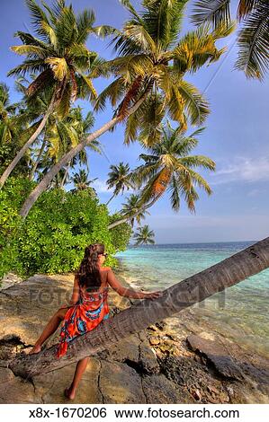 Girl watching the Ocean at the seashore, Biyadhoo island, Maldives View Large Photo Image Stock Photograph - Girl watching the Ocean at the seashore, Biyadhoo island, Maldives. Fotosearch