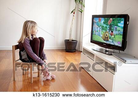 Girl watching TV at home View Large Photo Image Stock Image - Girl watching TV at home. Fotosearch