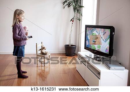 Girl watching TV at home View Large Photo Image Stock Image - Girl watching TV at home. Fotosearch