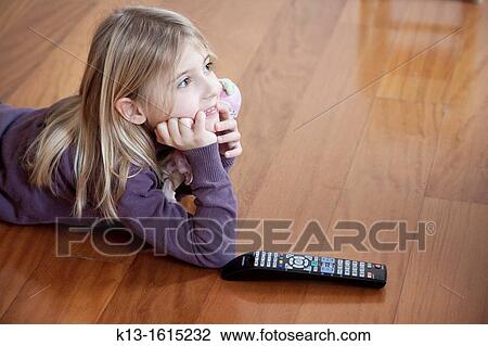 Girl watching TV at home View Large Photo Image Stock Image - Girl watching TV at home. Fotosearch