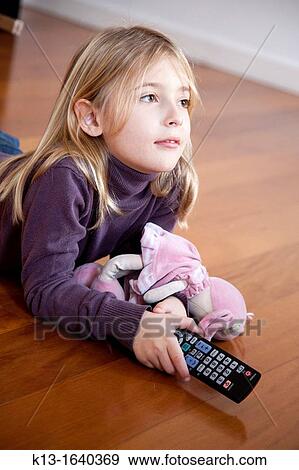 Girl watching TV at home View Large Photo Image Stock Photo - Girl watching TV at home. Fotosearch