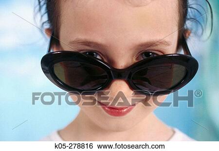 Stock Photograph - Girl wearing sunglasses. Fotosearch