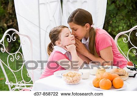Girl whispering a secret View Large Photo Image Stock Image - Girl whispering a secret. Fotosearch
