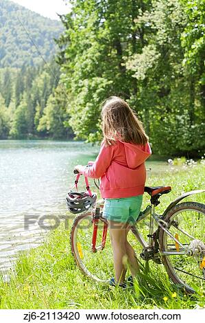 Girl with a bike. View Large Photo Image Stock Image - Girl with a bike.. Fotosearch