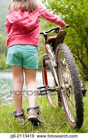 Girl with a bike. View Large Photo Image Stock Photo - Girl with a bike.. Fotosearch