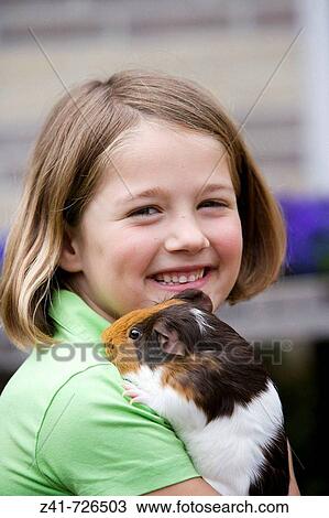 Girl with a guinea-pig View Large Photo Image Stock Image - Girl with a guinea-pig. Fotosearch