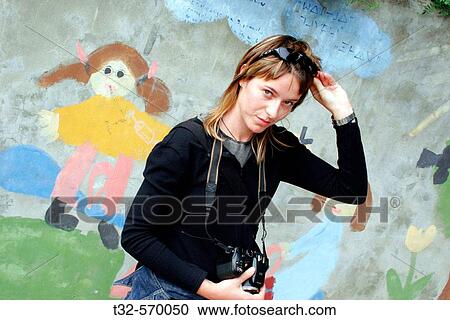 Stock Image - Girl with a painted wall on her back. Fotosearch