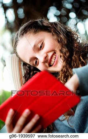 Stock Photo - Girl with a tablet. Fotosearch
