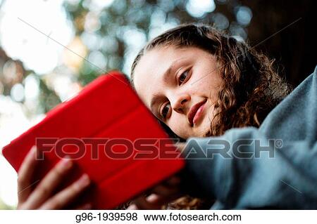 Stock Photo - Girl with a tablet. Fotosearch