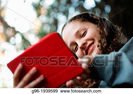 Stock Photo - Girl with a tablet. Fotosearch