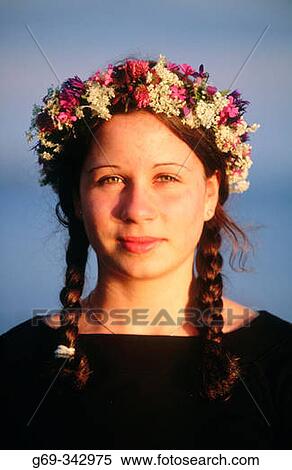 Stock Photography - Girl with a wreath made of flowers on Midsummer's Eve. V? sterbotten, Sweden. Fotosearch