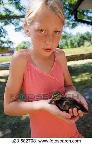 Girl with baby duck View Large Photo Image Stock Photo - Girl with baby duck. Fotosearch