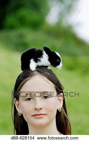 Girl with baby rabbit View Large Photo Image Picture - Girl with baby rabbit. Fotosearch