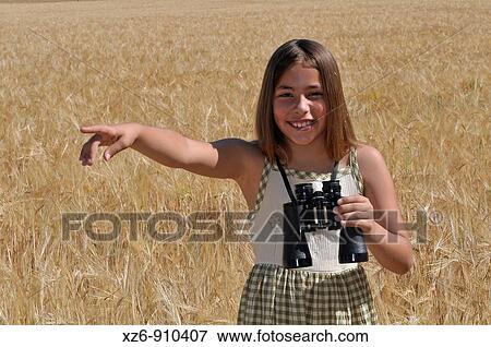 girl with binoculars in the field View Large Photo Image Stock Photo - girl with binoculars in the field. Fotosearch