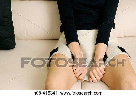 Girl with black and white mini skirt and black boots sat on a white sofa pulling her skirt down with two hands. View Large Photo Image Stock Image - Girl with black and white mini skirt and black boots sat on a white sofa pulling her skirt down with two hands.. Fotosearch