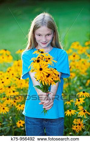 Stock Image - girl with bouquet of black eyed susans. Fotosearch