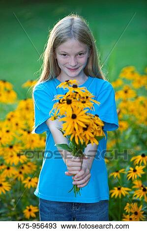 Stock Image - girl with bouquet of black eyed susans. Fotosearch