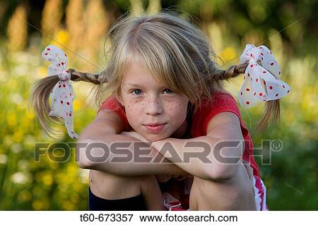 Girl with braids (pigtails) in her hair enjoying the summer, costume party theme View Large Photo Image Stock Photo - Girl with braids (pigtails) in her hair enjoying the summer, costume party theme. Fotosearch