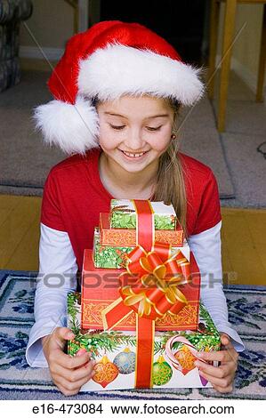 Girl with Christmas presents View Large Photo Image Picture - Girl with Christmas presents. Fotosearch