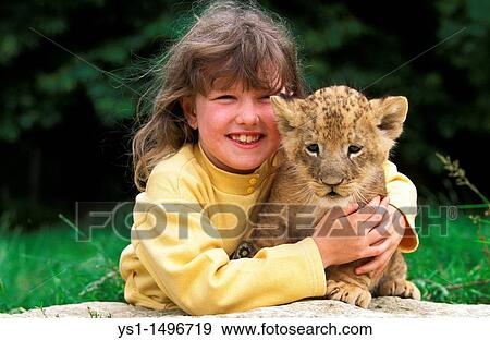 Girl with Cub, African Lion, panthera leo View Large Photo Image Stock Photo - Girl with Cub, African Lion, panthera leo. Fotosearch
