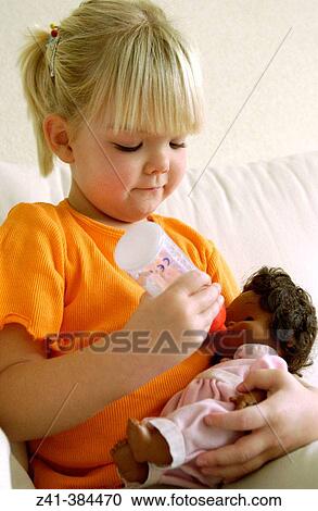 Stock Image - Girl with doll. Fotosearch