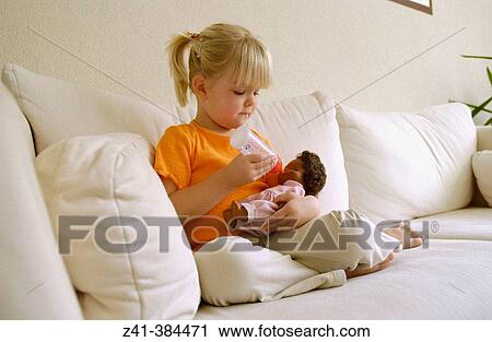 Girl with doll View Large Photo Image Stock Image - Girl with doll. Fotosearch