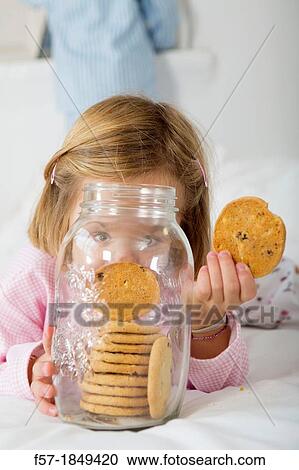 Girl with her hand in the cookie jar View Large Photo Image Stock Image - Girl with her hand in the cookie jar. Fotosearch