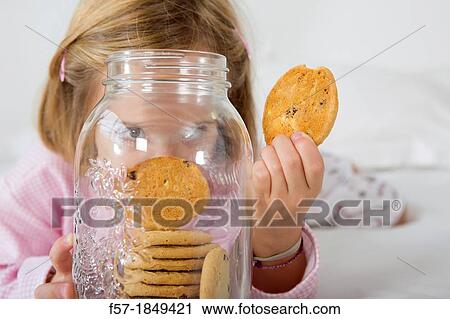 Girl with her hand in the cookie jar View Large Photo Image Stock Image - Girl with her hand in the cookie jar. Fotosearch