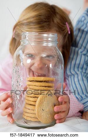 Girl with her hand in the cookie jar View Large Photo Image Stock Photo - Girl with her hand in the cookie jar. Fotosearch