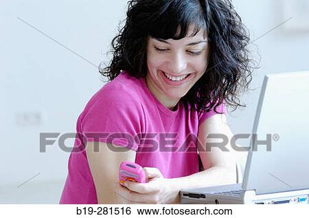 Girl with laptop and mobile phone portrait View Large Photo Image Stock Photograph - Girl with laptop and mobile phone portrait. Fotosearch