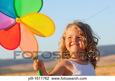 Stock Image - girl with pinwheel. Fotosearch