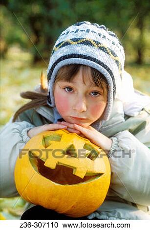 Girl with pumpkin in Halloween View Large Photo Image Stock Image - Girl with pumpkin in Halloween. Fotosearch
