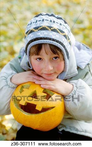 Girl with pumpkin in Halloween View Large Photo Image Stock Image - Girl with pumpkin in Halloween. Fotosearch