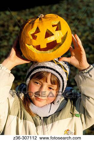 Girl with pumpkin in Halloween View Large Photo Image Stock Image - Girl with pumpkin in Halloween. Fotosearch