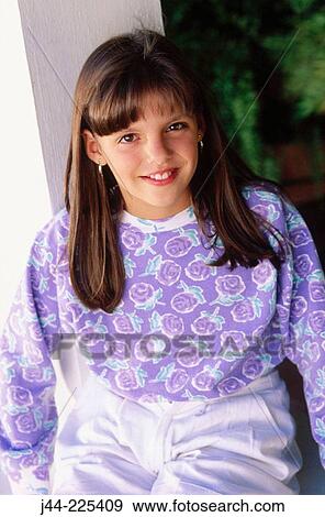 Girl with purple flower sweater smiling View Large Photo Image Stock Photo - Girl with purple flower sweater smiling. Fotosearch