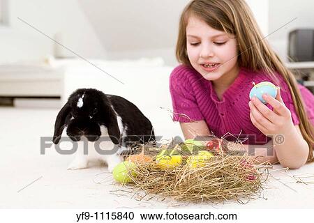 Girl with rabbit and Easters Eggs. View Large Photo Image Stock Image - Girl with rabbit and Easters Eggs.. Fotosearch