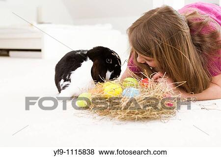 Girl with rabbit and Easters Eggs. View Large Photo Image Stock Photo - Girl with rabbit and Easters Eggs.. Fotosearch