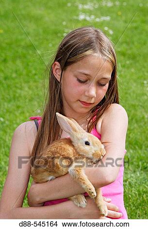Girl with rabbit View Large Photo Image Picture - Girl with rabbit. Fotosearch