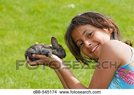 Girl with rabbit View Large Photo Image Picture - Girl with rabbit. Fotosearch