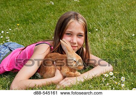 Stock Image - Girl with rabbit. Fotosearch