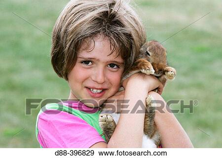 Girl with rabbit View Large Photo Image Stock Photo - Girl with rabbit. Fotosearch