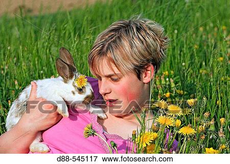 Stock Photo - Girl with rabbit. Fotosearch