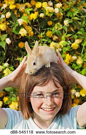 Stock Photo - Girl with rabbit. Fotosearch